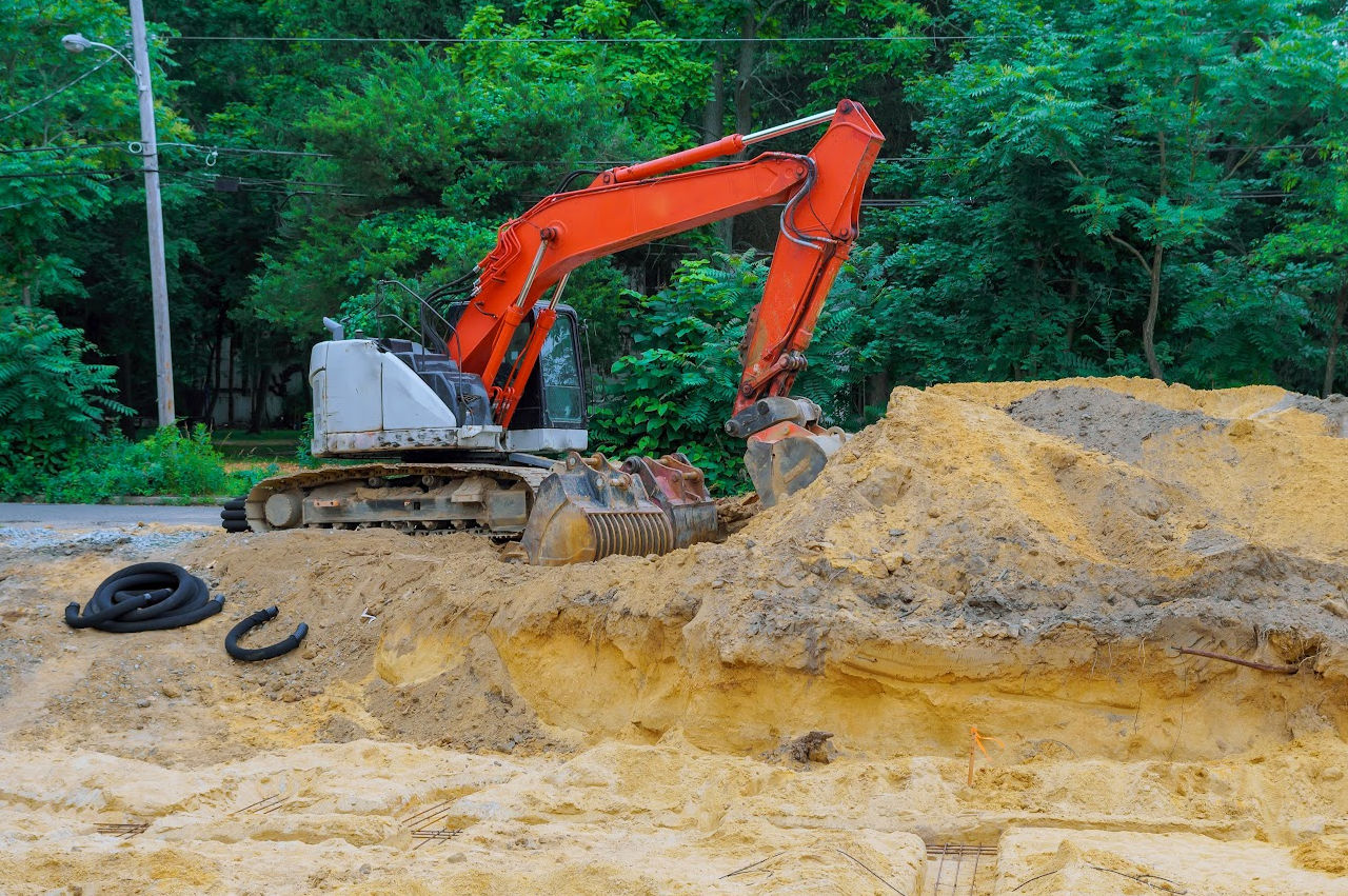 Image of an excavator digging a septic tank hole Image of an excavator digging a septic tank hole