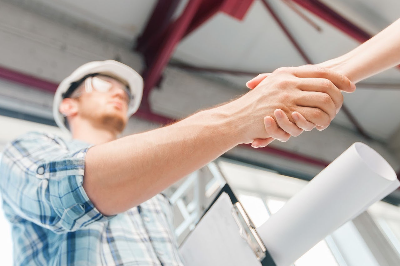 Image of two contractors shaking hands