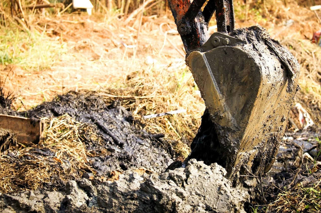 image of an excavator digging out a septic tank image of an excavator digging out a septic tank