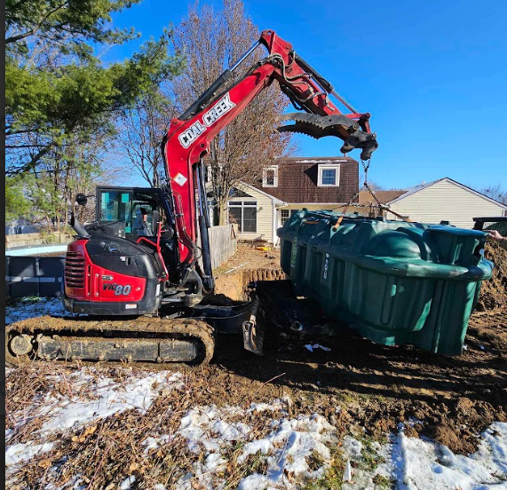 Excavator installing a septic tank