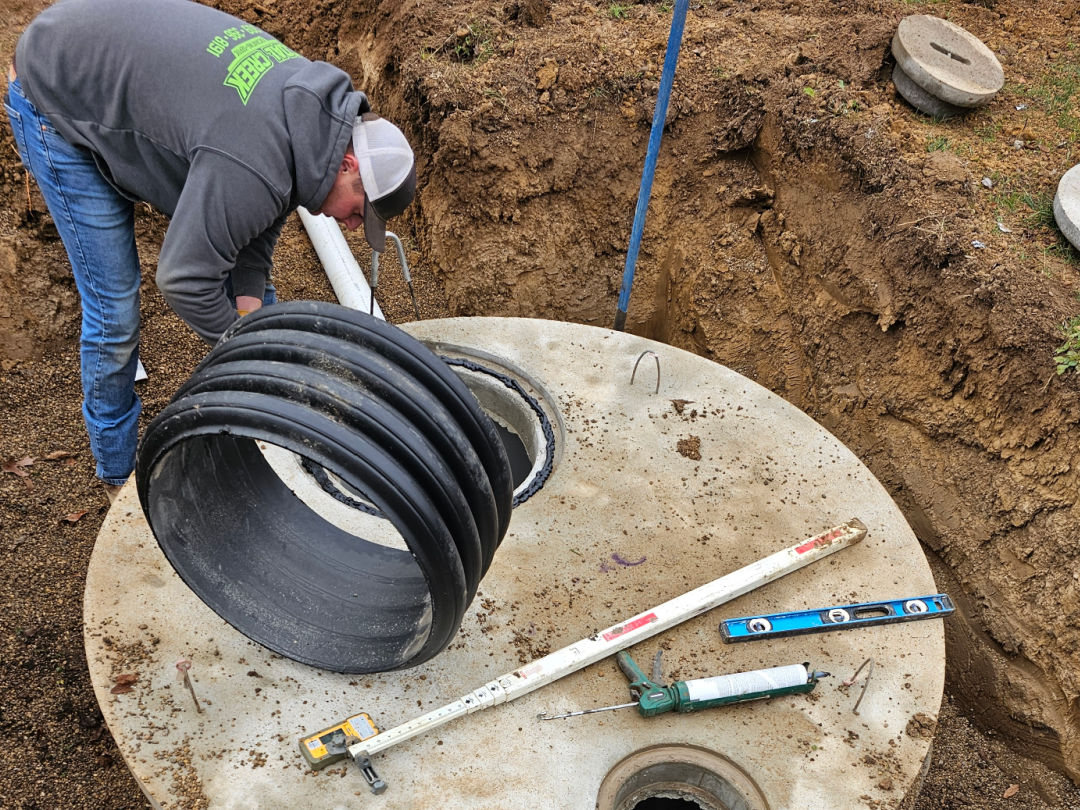 Image of installing septic risers on a content tank