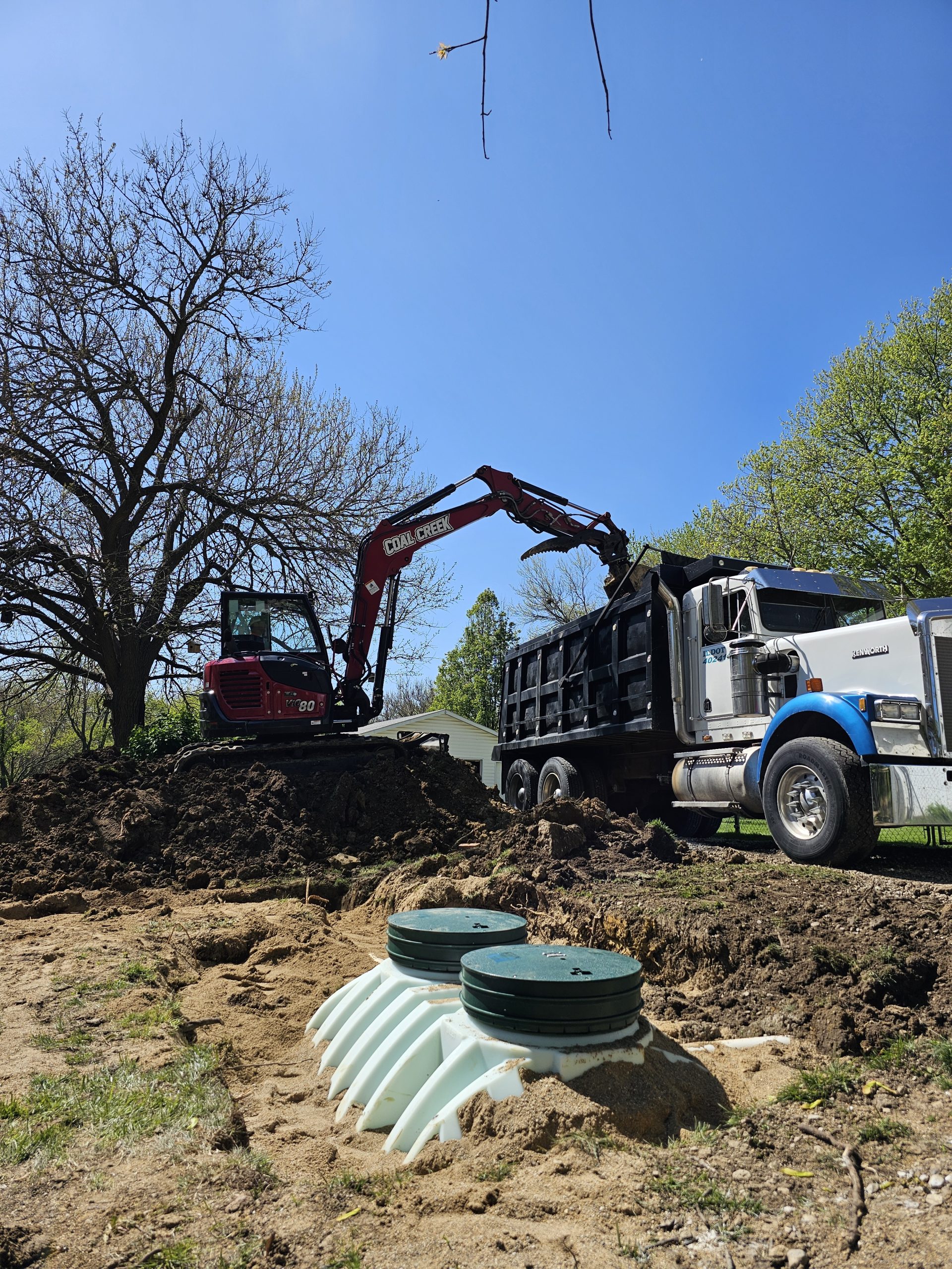 Hart, Peoria Excavator unloads dirt into a dump truck