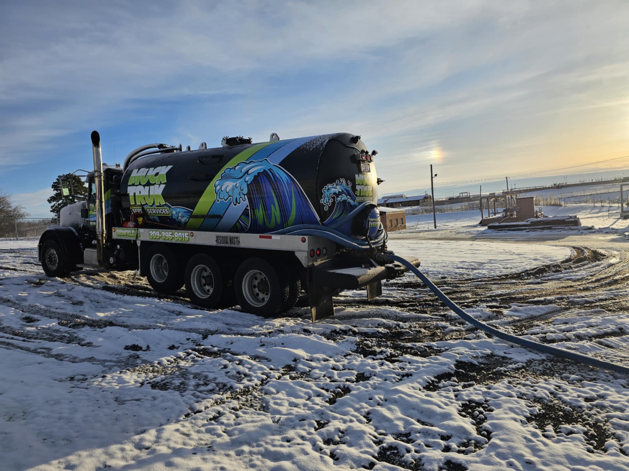 IMG_6829 Septic truck with hose on snowy ground