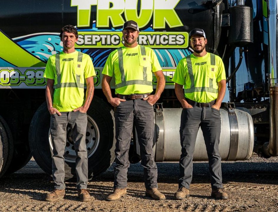Muck Truck Photos Three men in safety vests by a septic truck